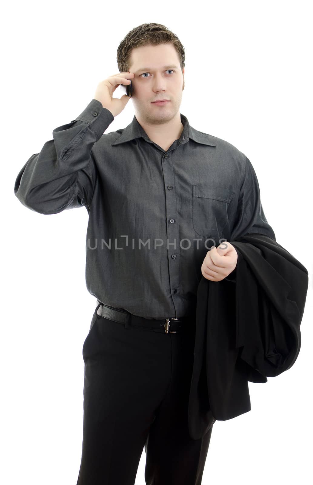 Portrait of a handsome young business man talking on mobile phone. Isolated on white background with copy space.