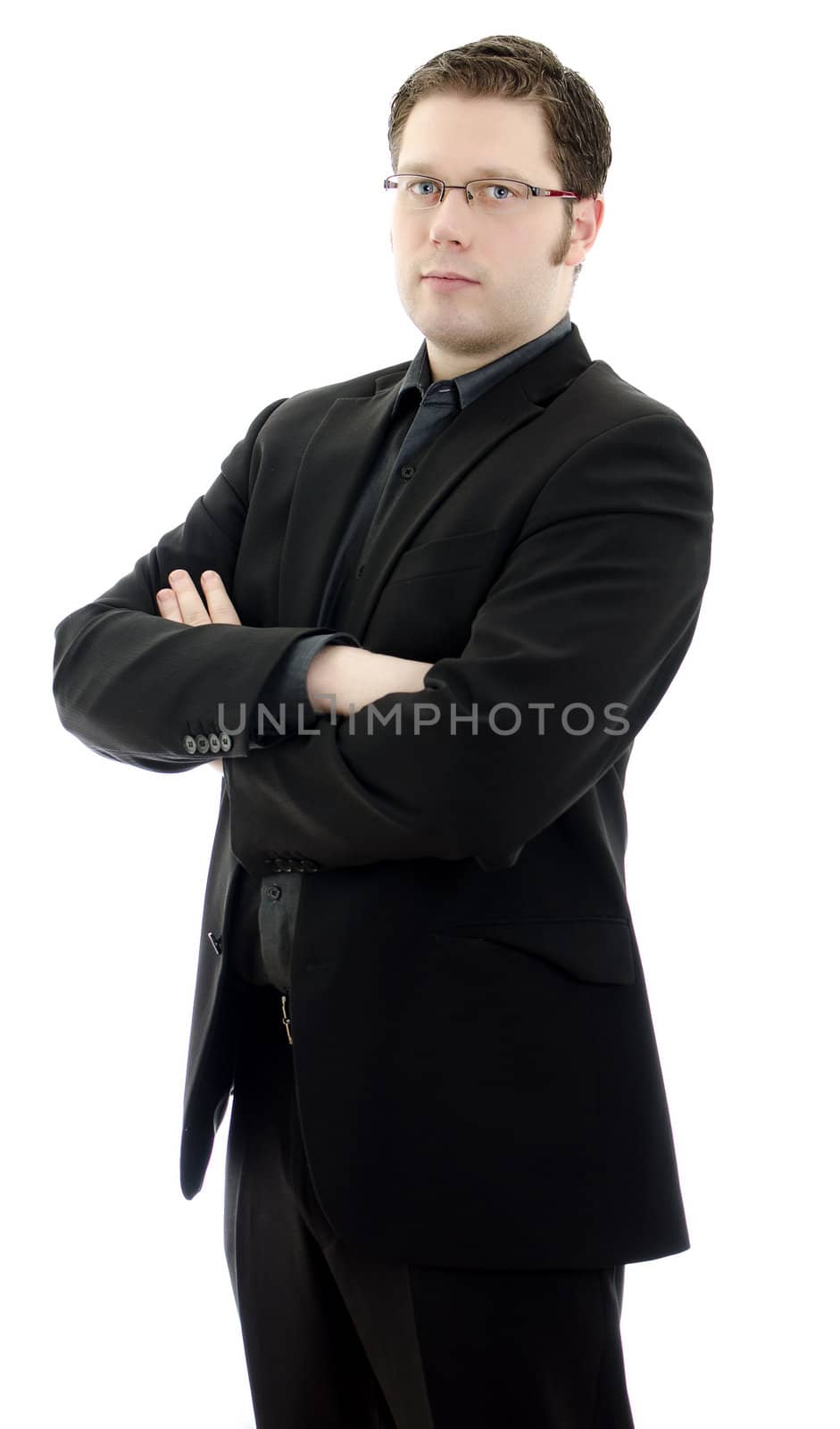 Portrait of a handsome young business man in glasses with arms crossed. Isolated on white background with copy space.