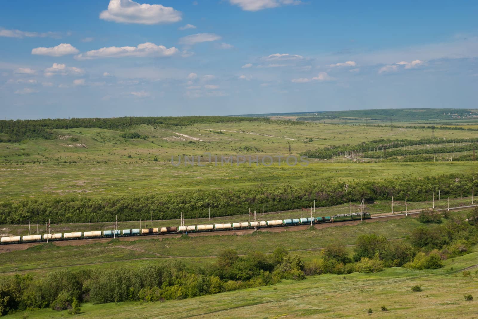 Freight Train Going by Railway Against Summer Landscape