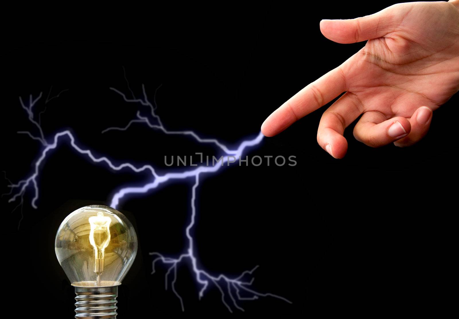 Hand pointing to bulb with an electric current inbetween