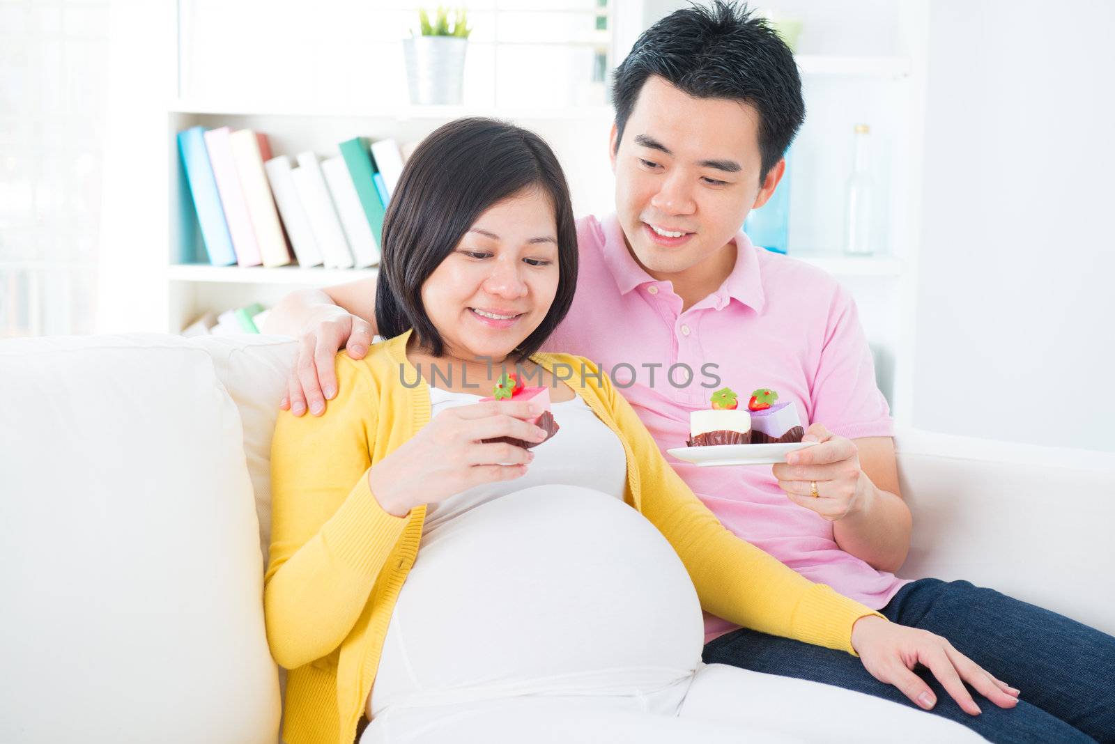 Asian pregnant woman eating cake  by szefei