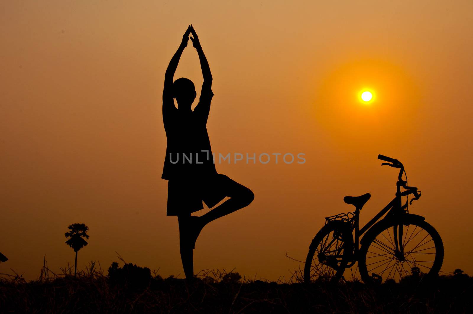 silhouette of boy Yoga with bicycle