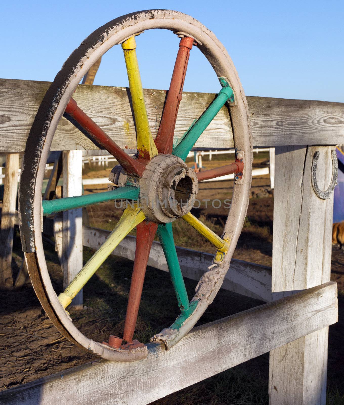 Old Wheel and Horseshoes on fence horse farm