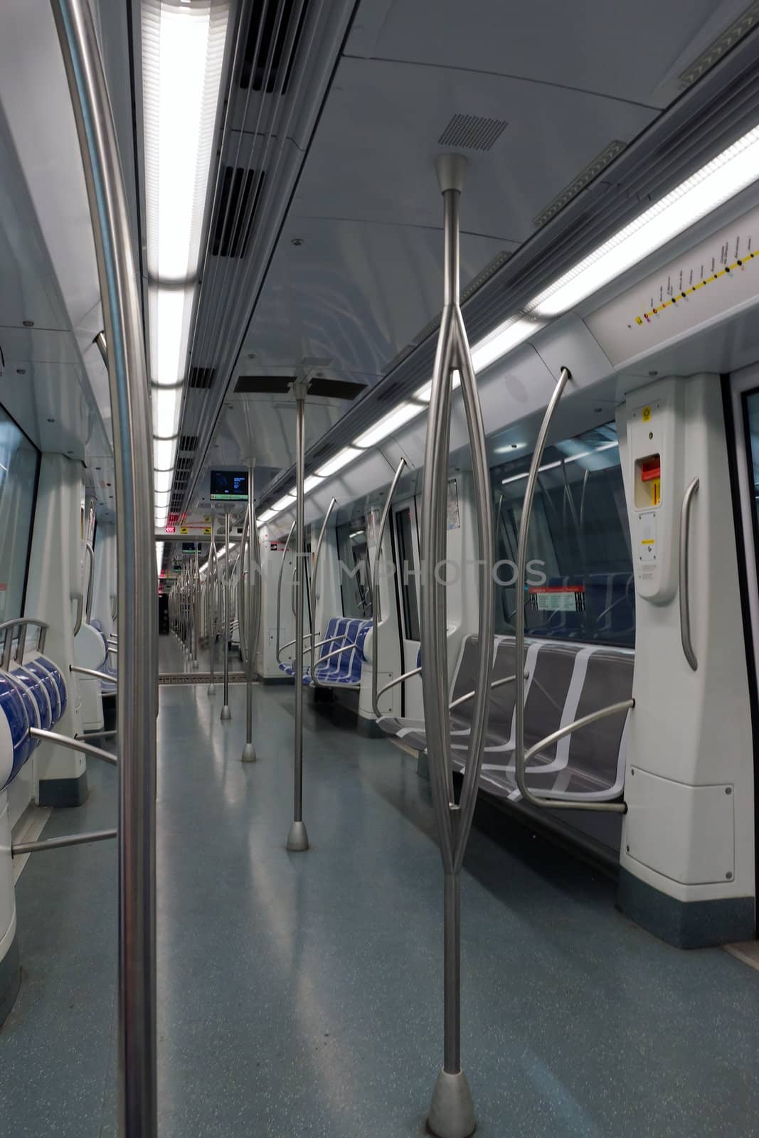Interior of a passenger metro train with empty seats