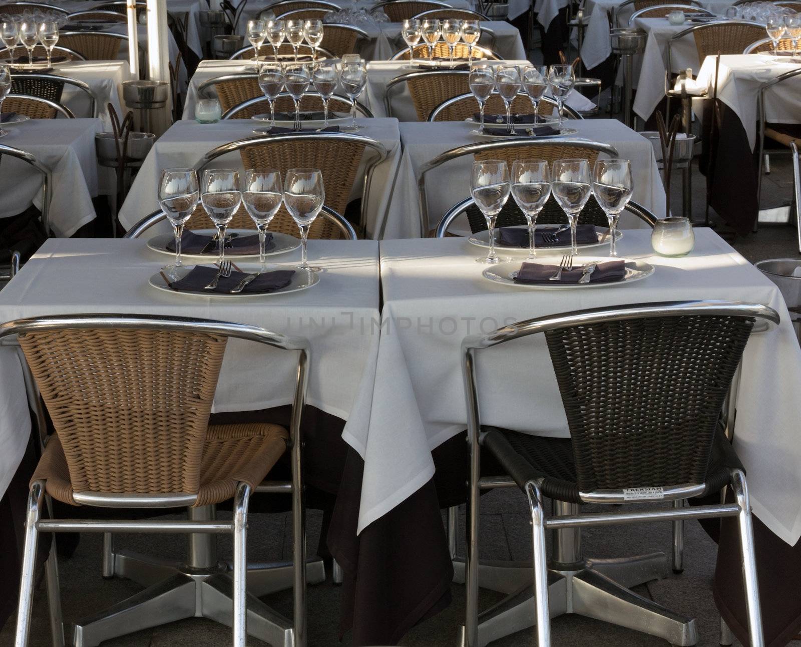 Empty glasses and plates, silverware on table in restaurant