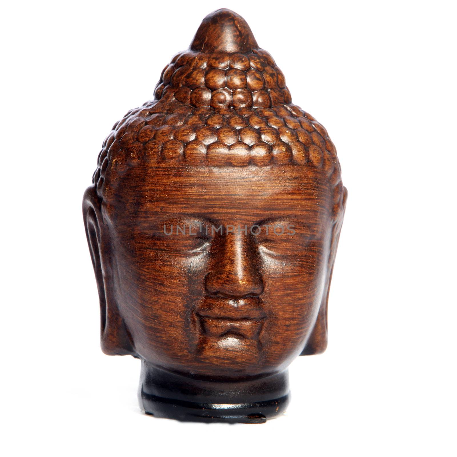 Wooden Buddha head carving in Asian style with eyes closed in meditation, prayer and serenity in the pursuit of enlightenment