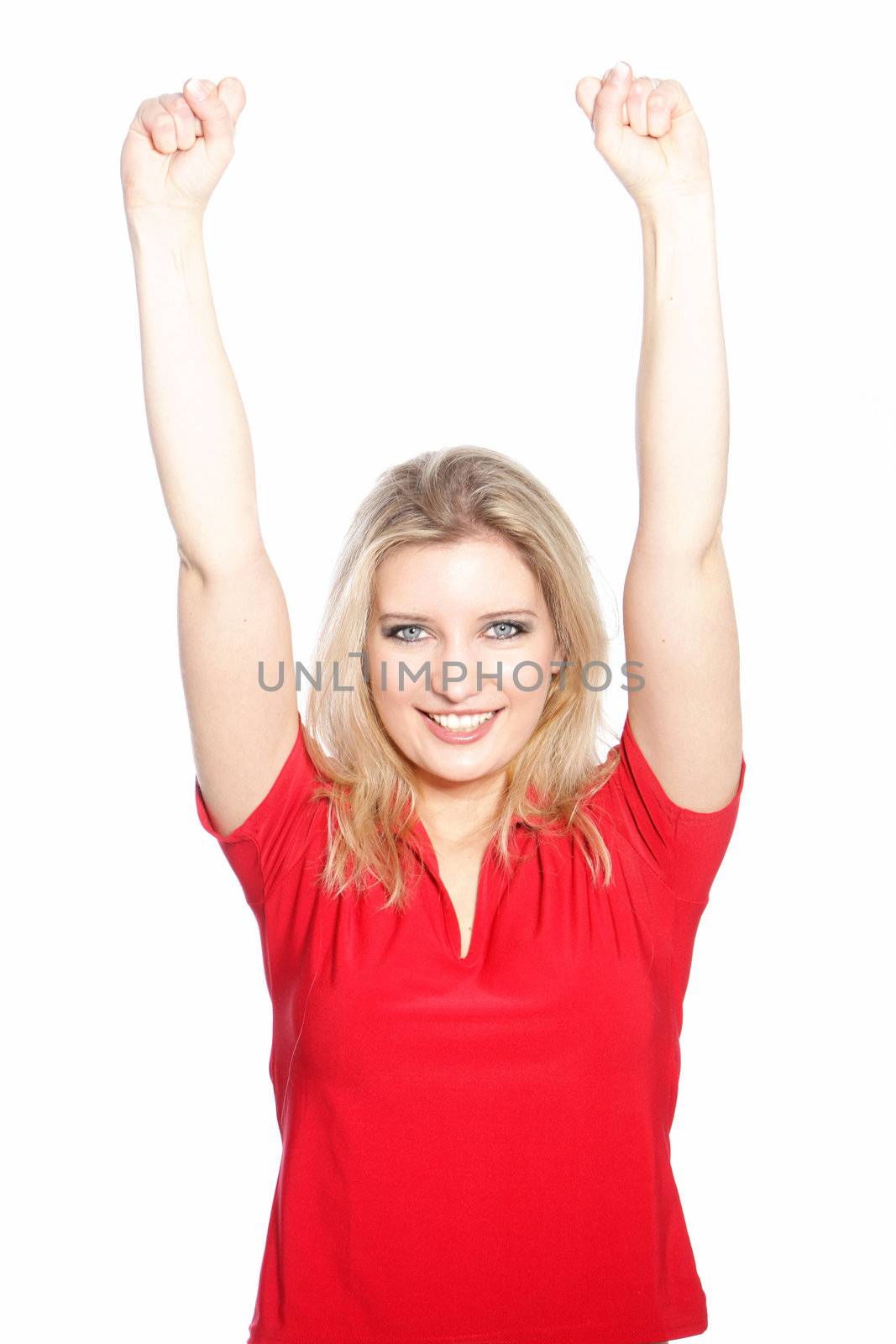 Triumphant attractive young woman raising her arms above her head with a lovely smile isolated on white