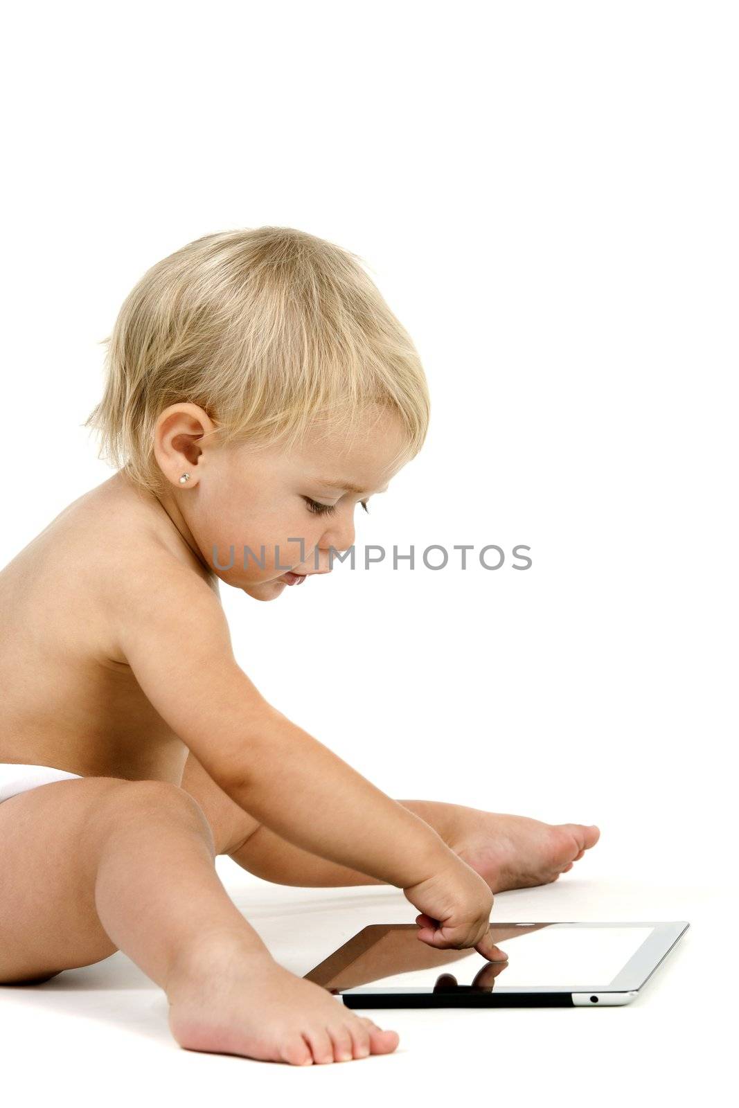 Baby girl playing with tablet. Isolated on white background.