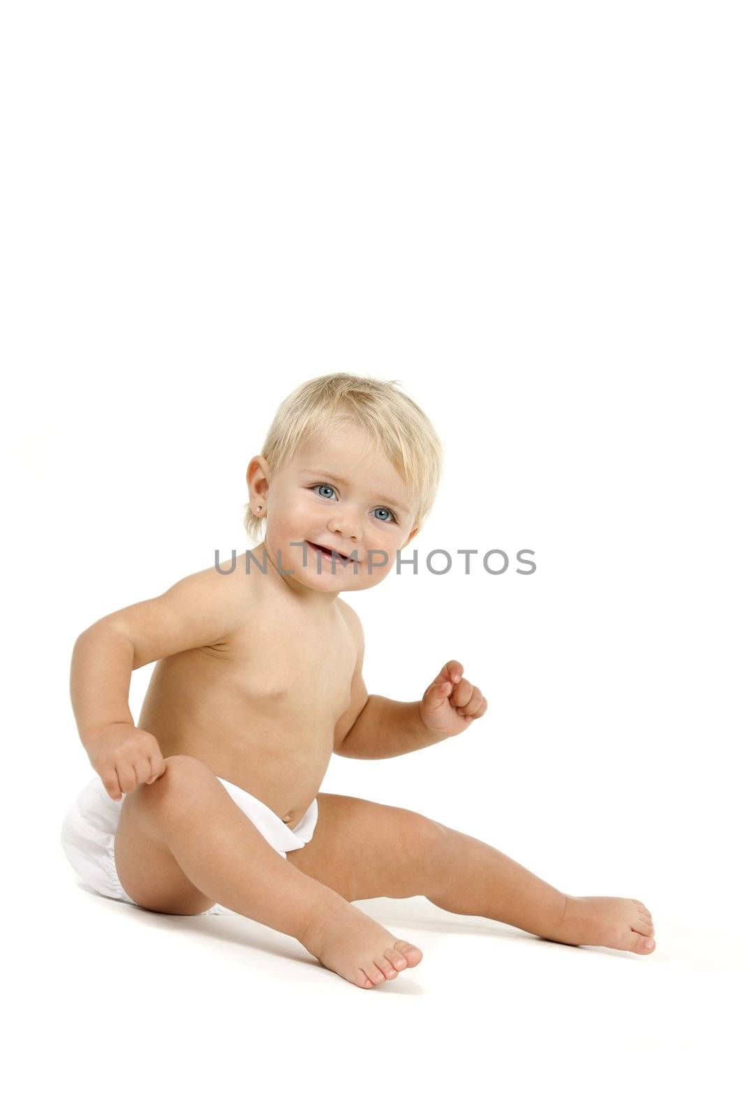 Blue eyed baby girl n huggies sitting with tablet. Isolated on white background.