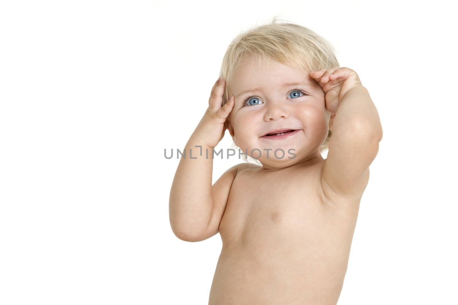 Blue eyed baby girl smiling with hands on her head. Isolated on white background.