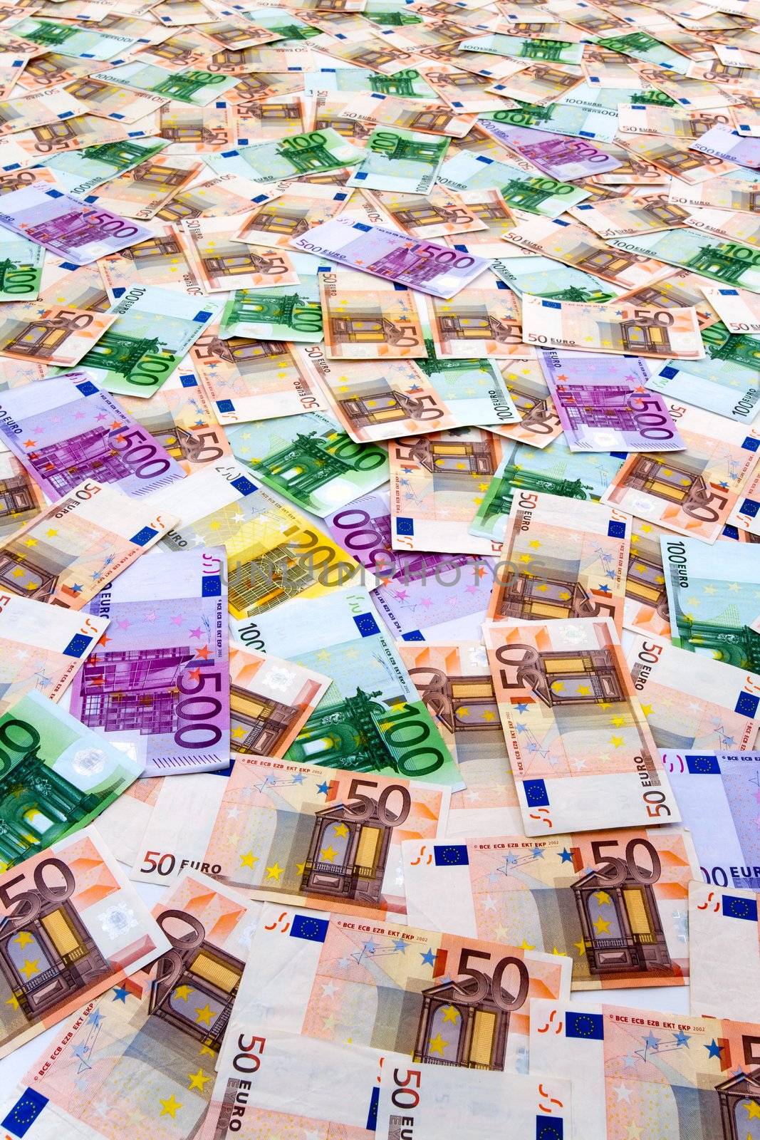 Multiple euro currency banknotes arranged  forming a collage on flat surface.Backing image.