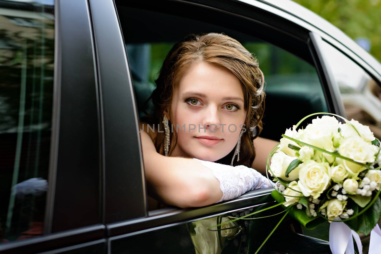 portrait of a pretty bride in a car window
