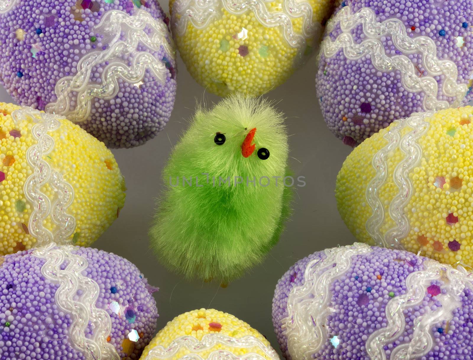green Easter chicks surrounded by decorated eggs