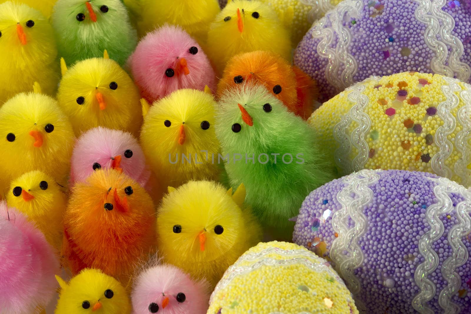 Group of funny Fluffy coloured Easter chickens with decorated eggs