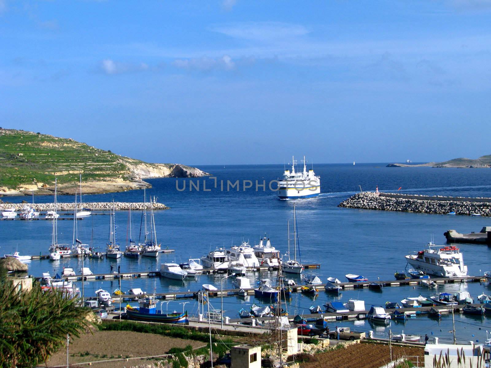 A ferry berthing into Mgarr Harbour in Gozo, Malta.