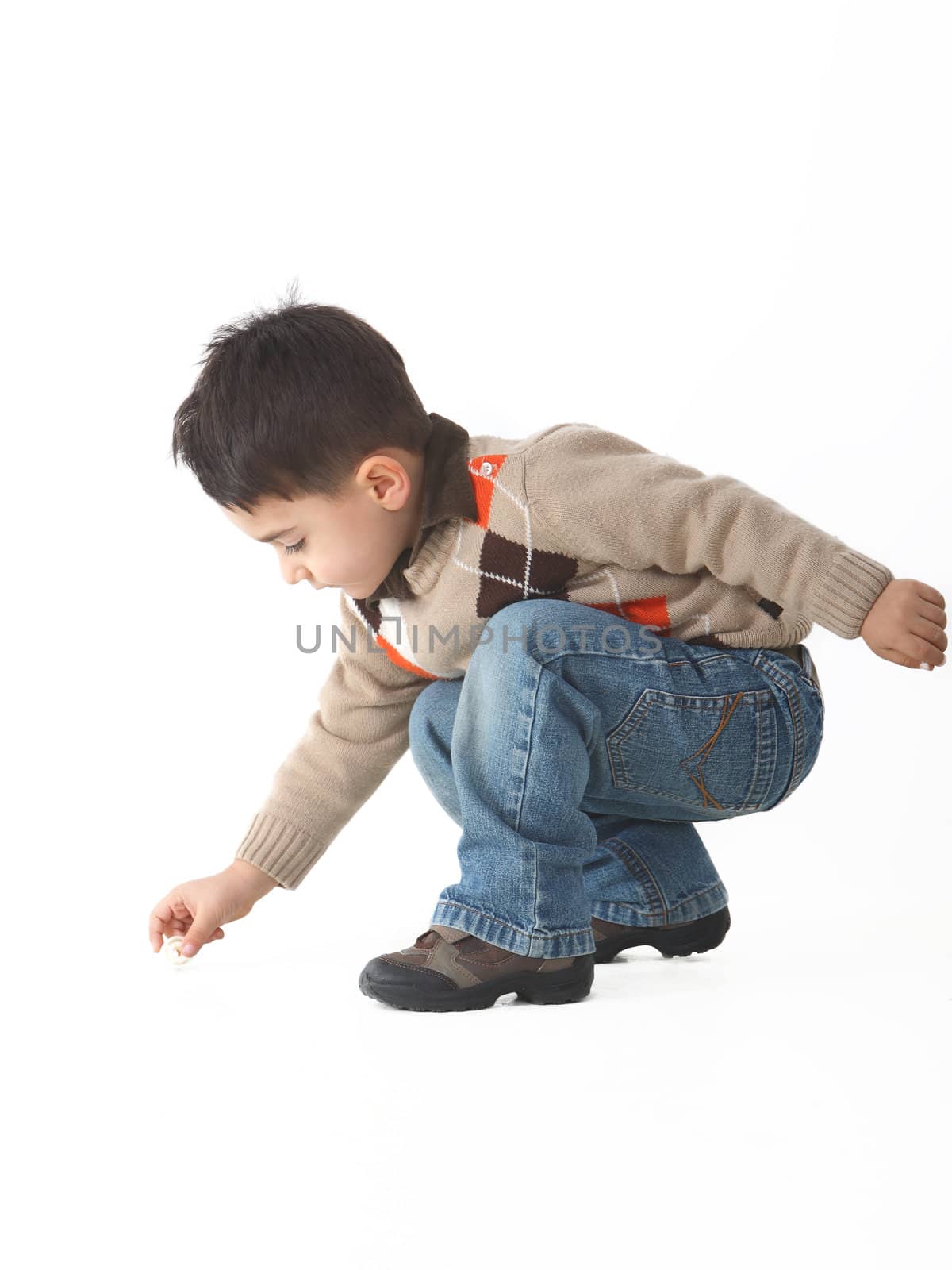 Adorable child in studio crouching by shamtor