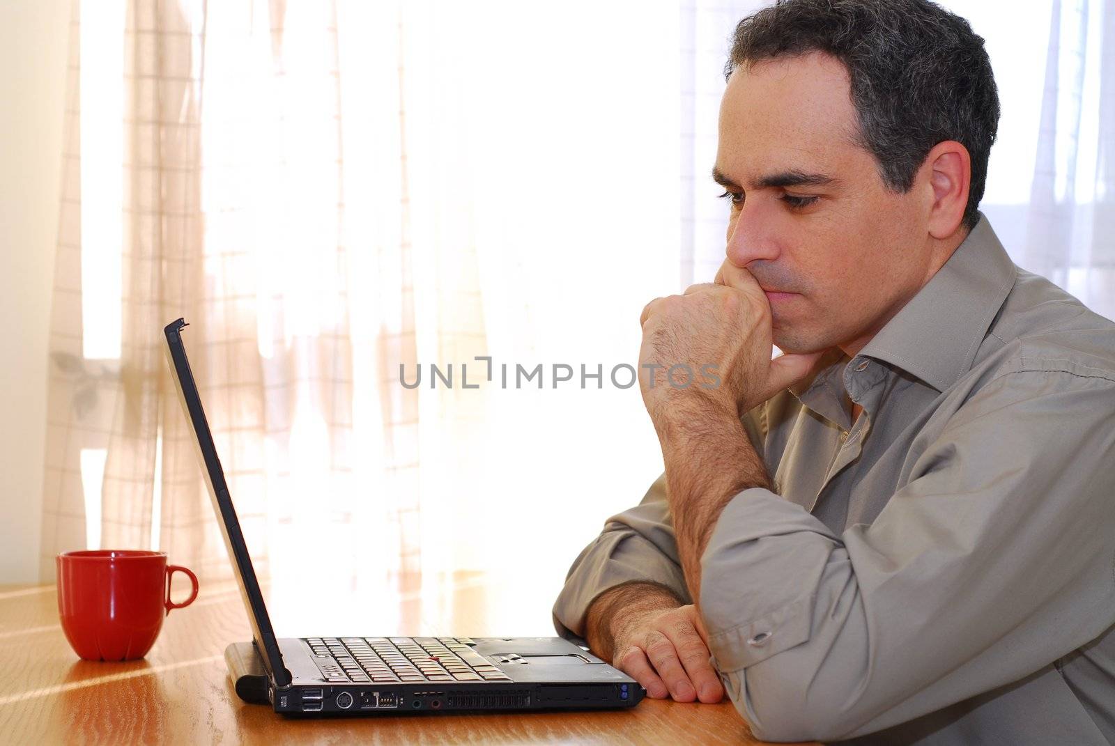 Man sitting at a desk and looking into his computer