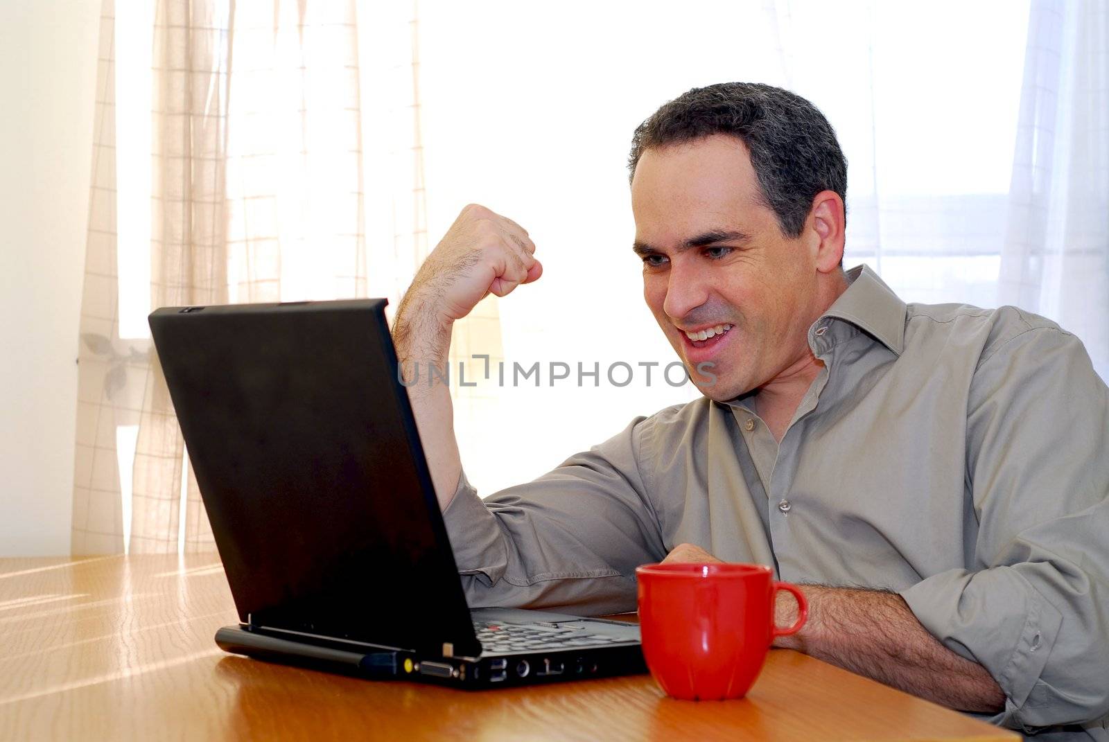 Man sitting at a desk and looking into his computer