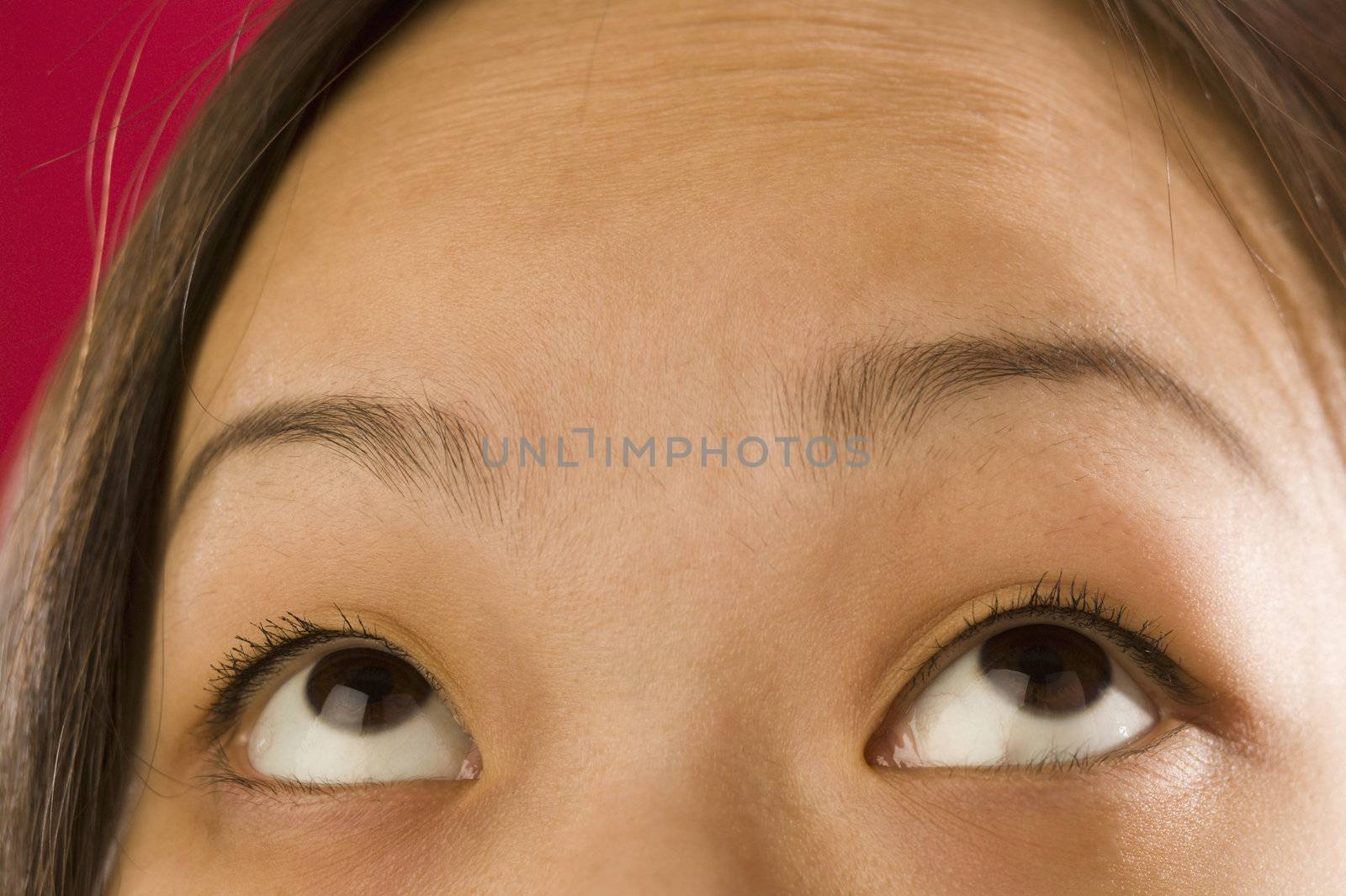 Asian woman's eyes looking up by edbockstock