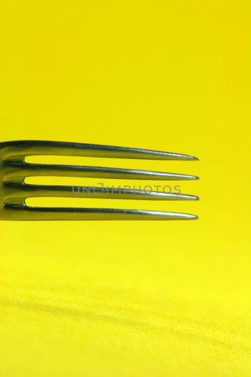 food and reasturants concepts fork detail in yellow background