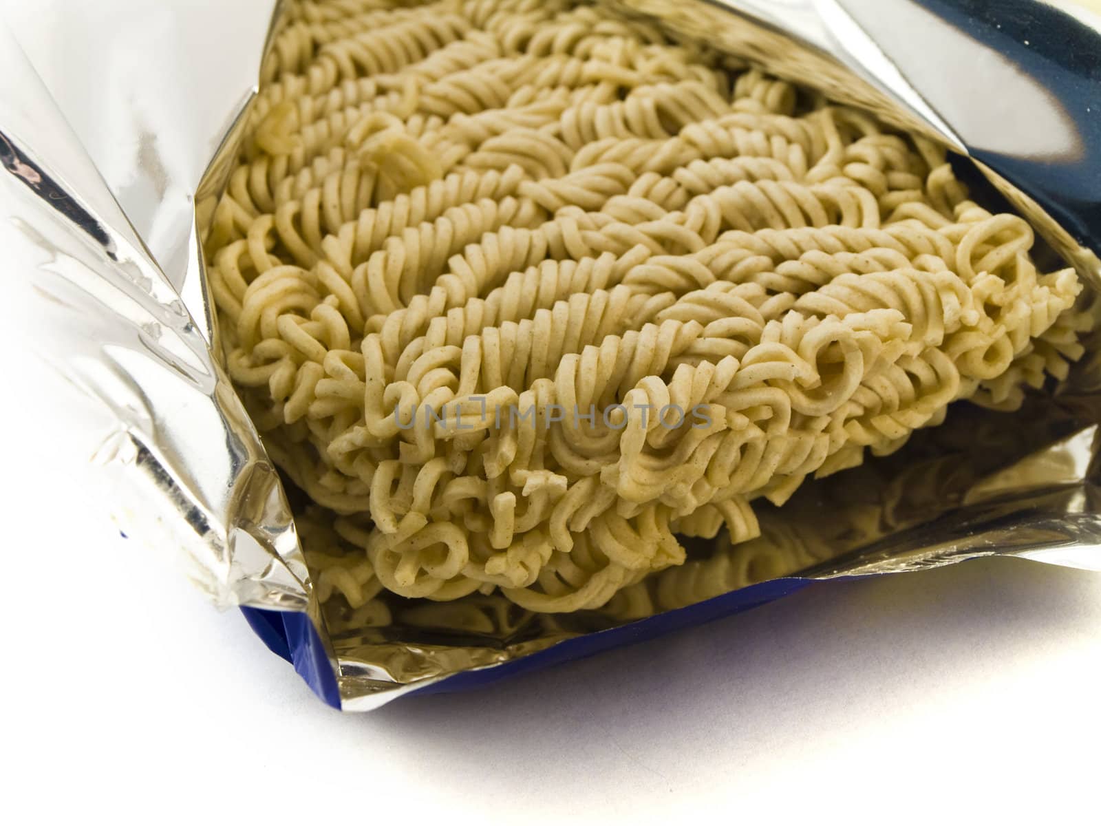 Dried Egg Noodles in Foil on White Background by bobbigmac