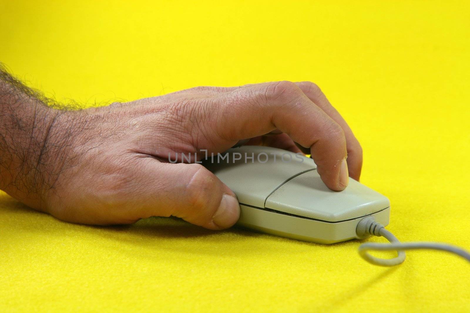 hand clicking a mouse in yellow background
