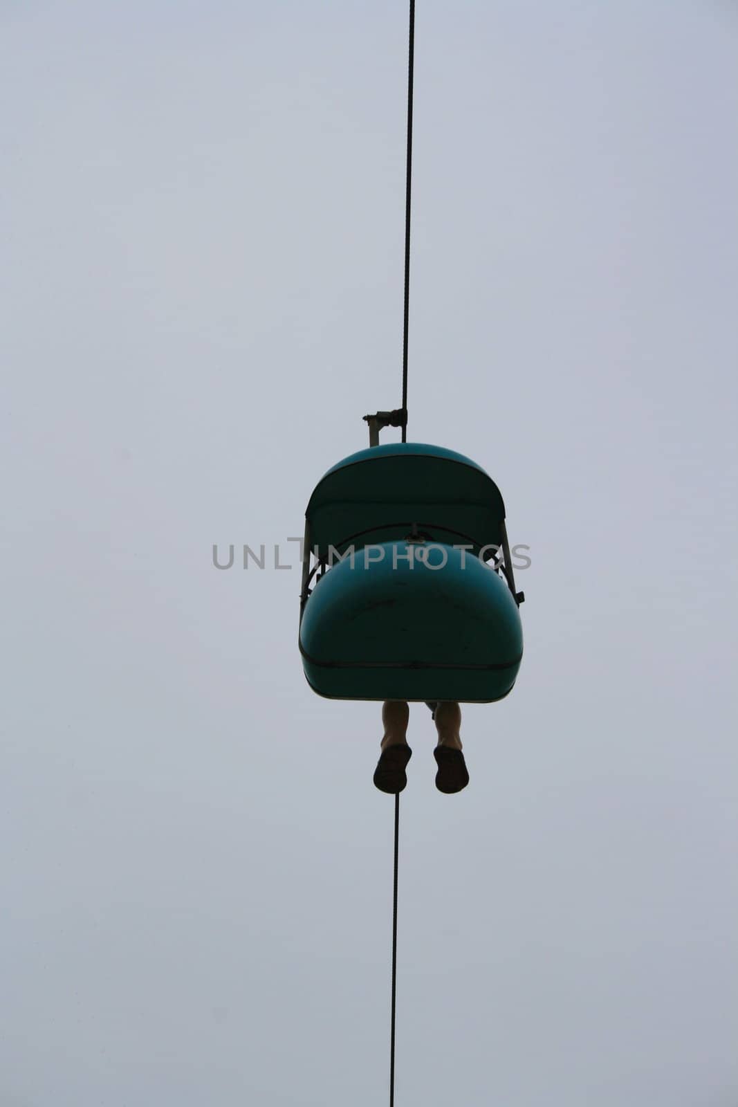 Carousel ride high over sky.