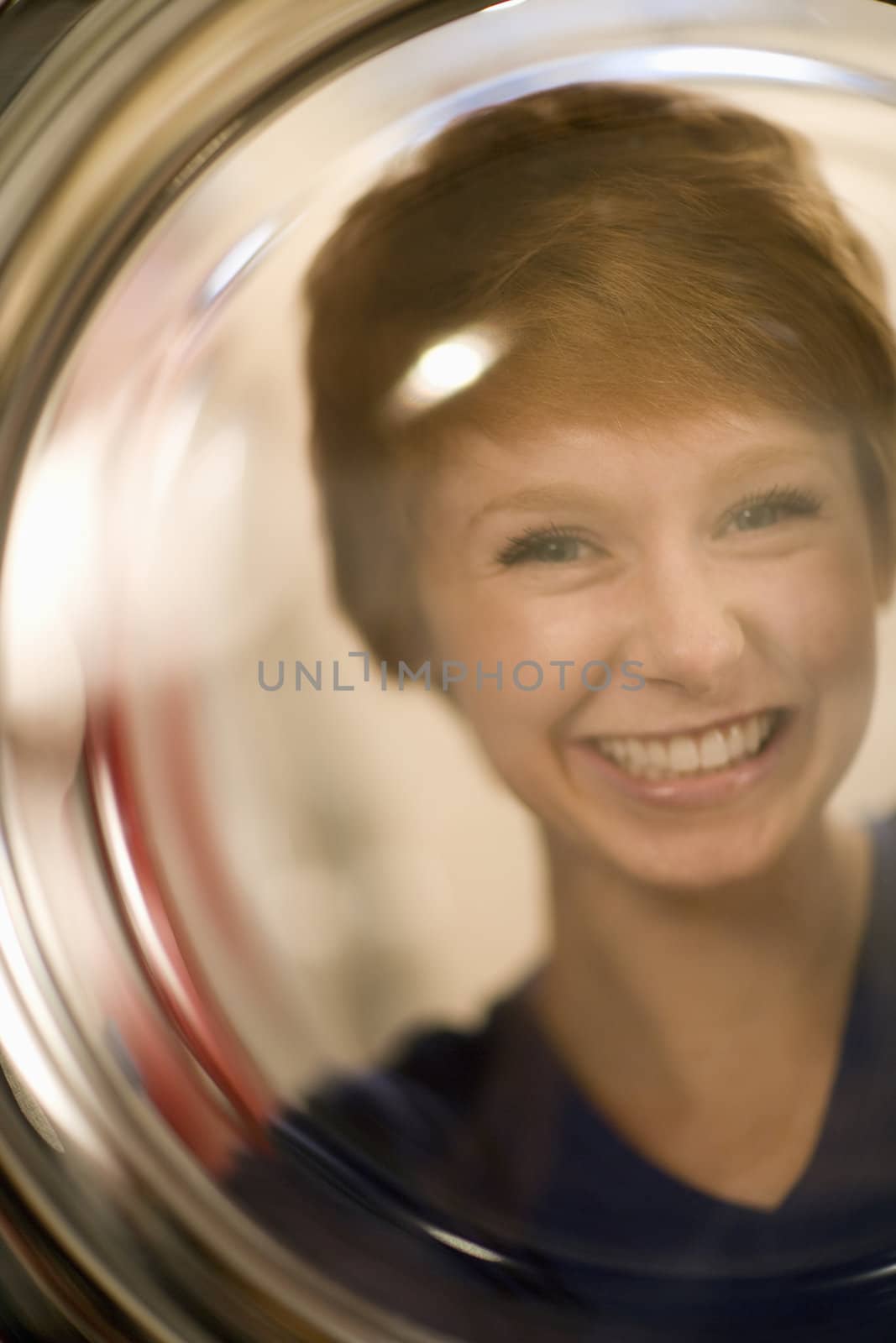 Smiling woman portrait through glass by edbockstock