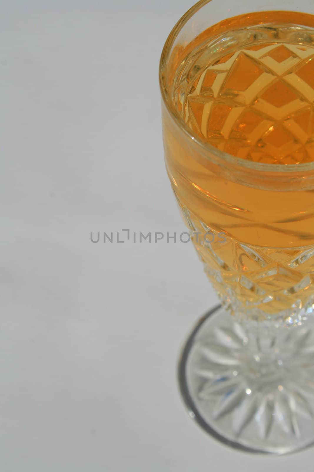 Close up of a crystal glass with a drink.
