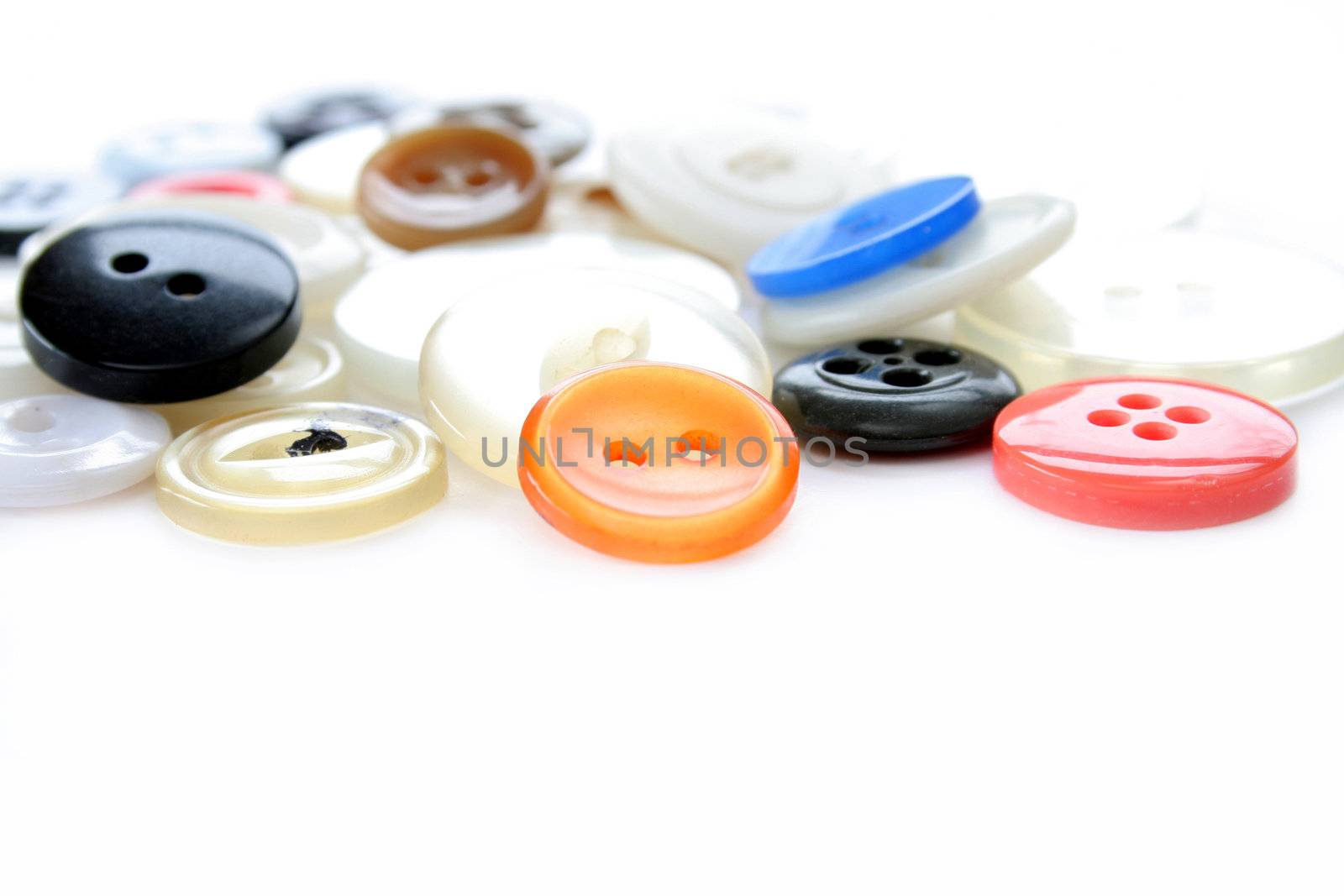 close up of buttons fading into the background. Isolated on white with copyspace. Used a selective focus and shallow depth of field..