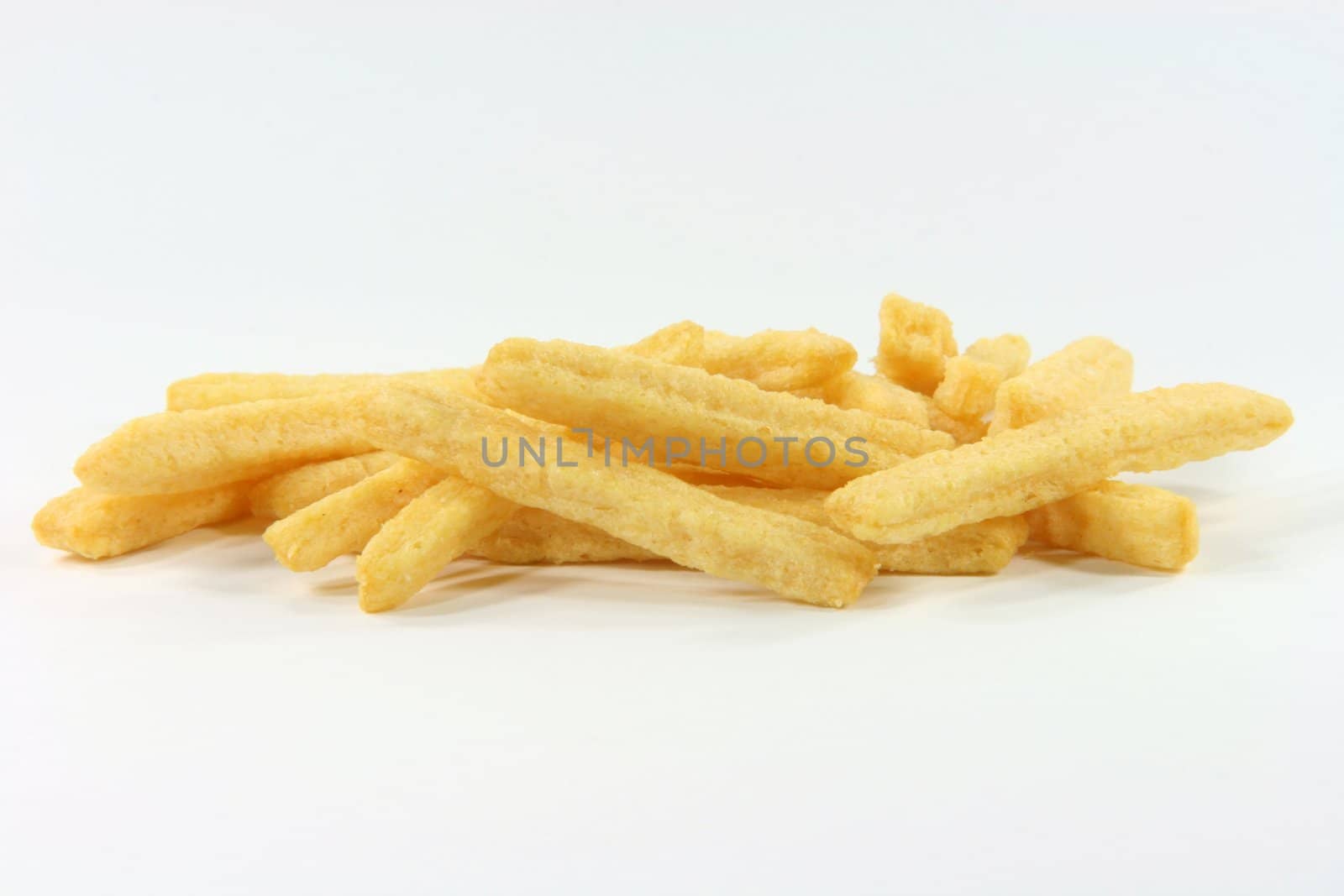 closeup of crunchy yellow cheese snacks in white background