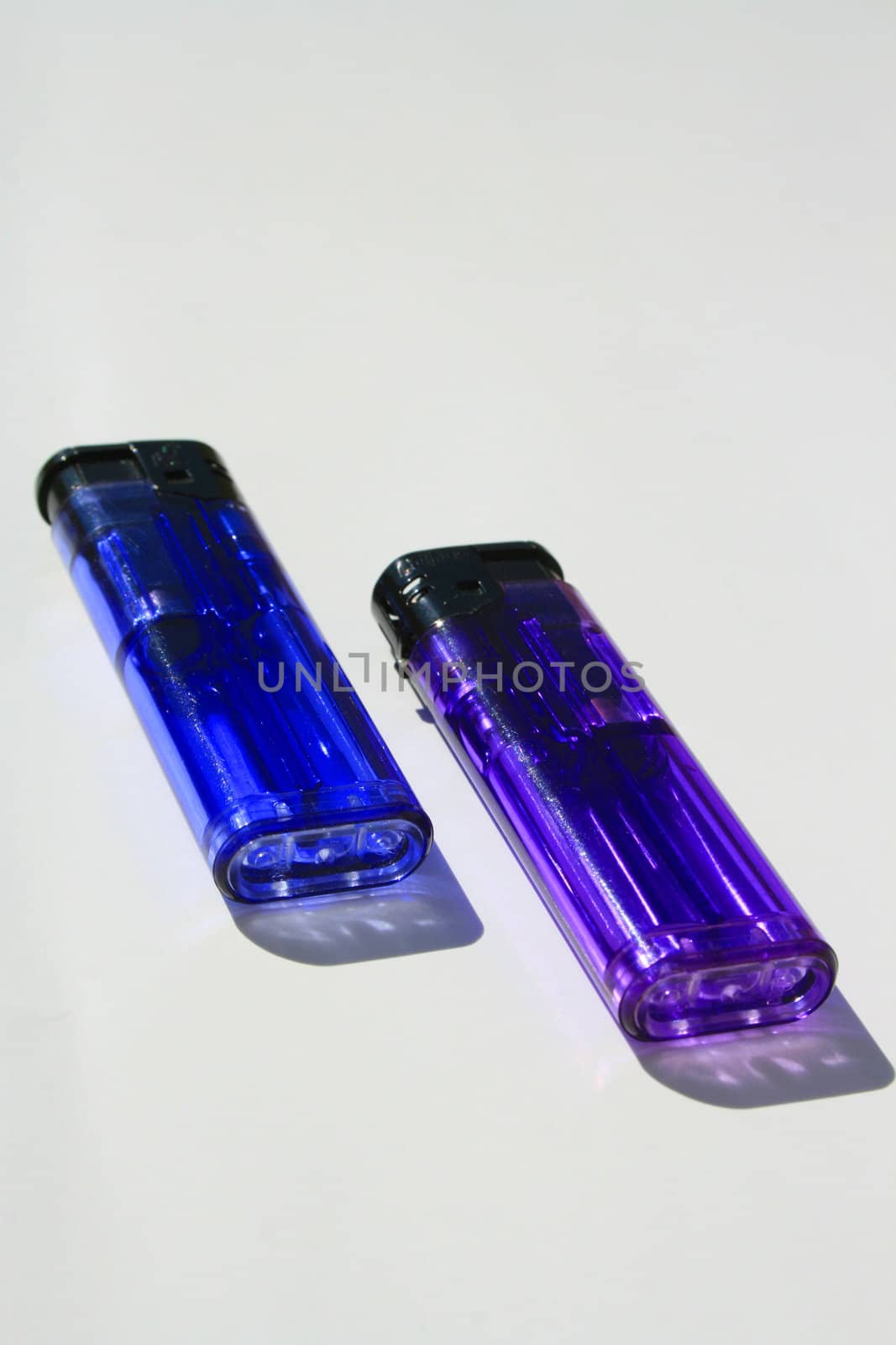 Close up of the two colorful lighters.
