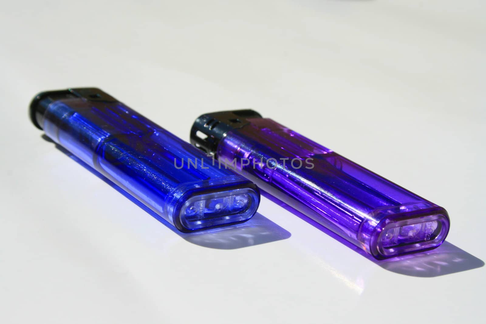 Close up of the two colorful lighters.
