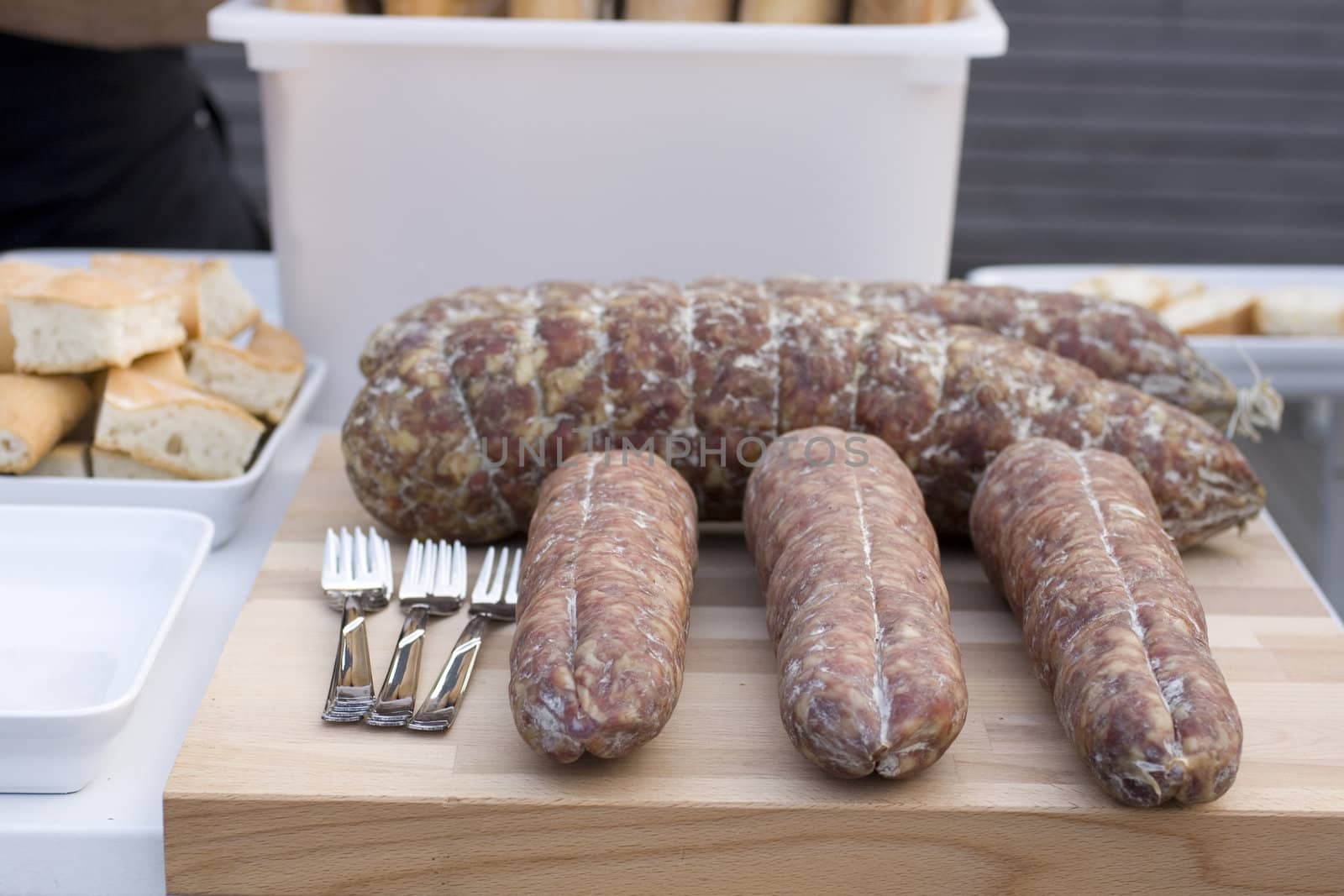 Salame and forks on cutting board