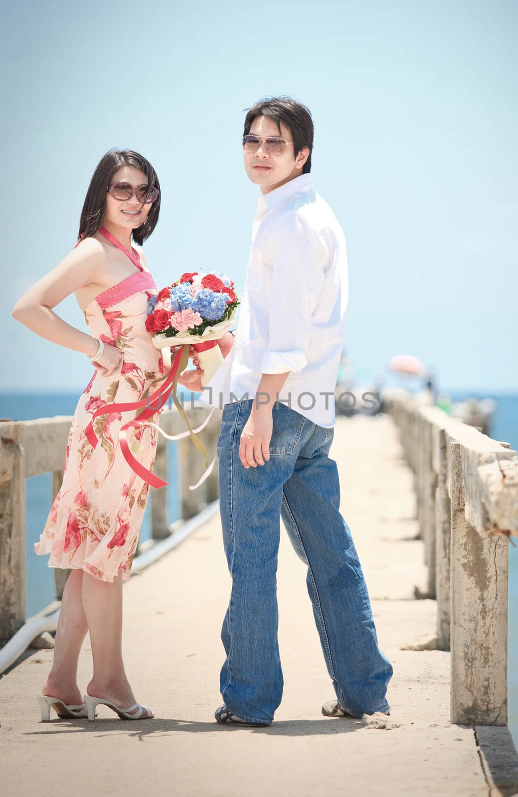 portrait of couples at pier on the beach