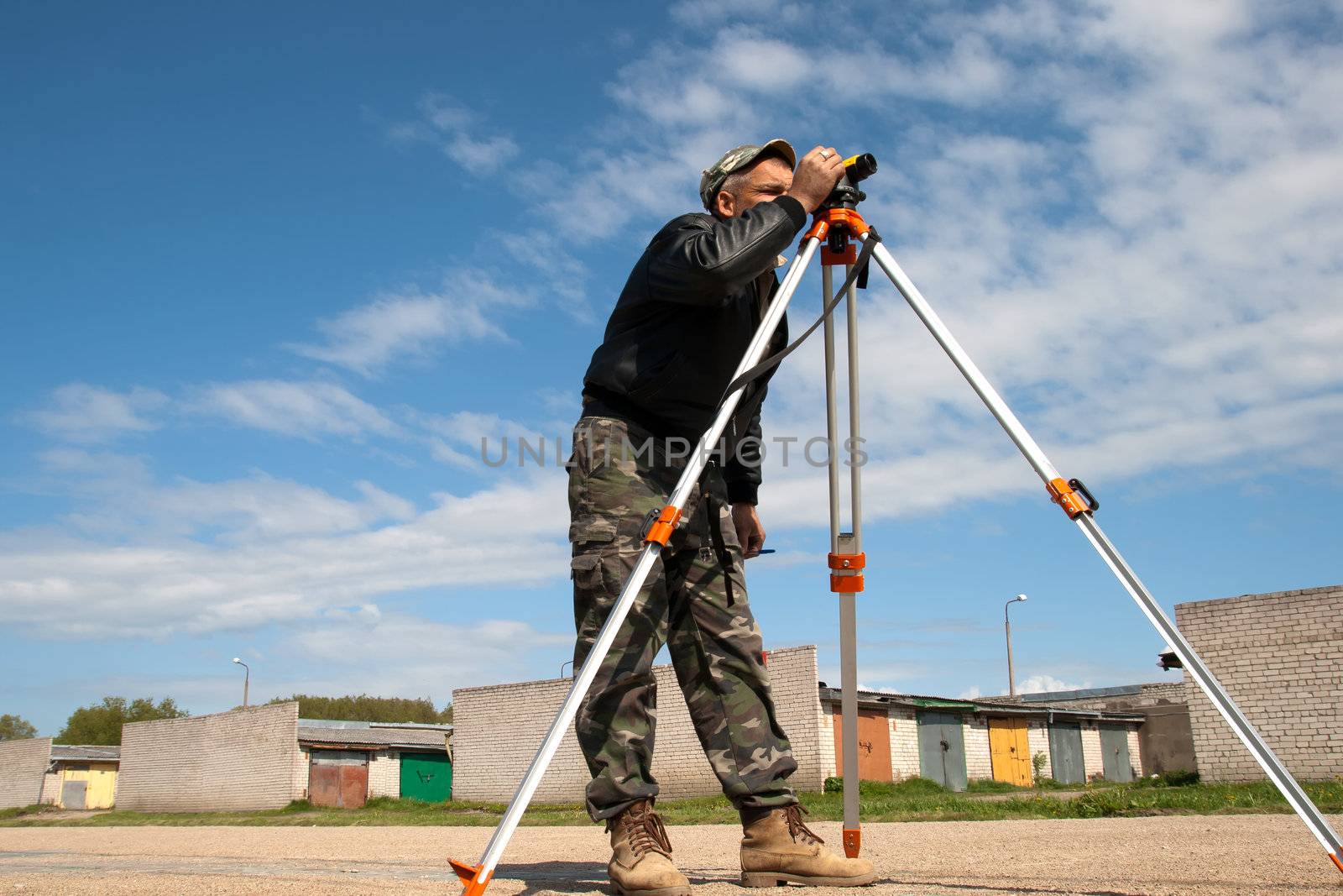 Surveyor measuring land for construction