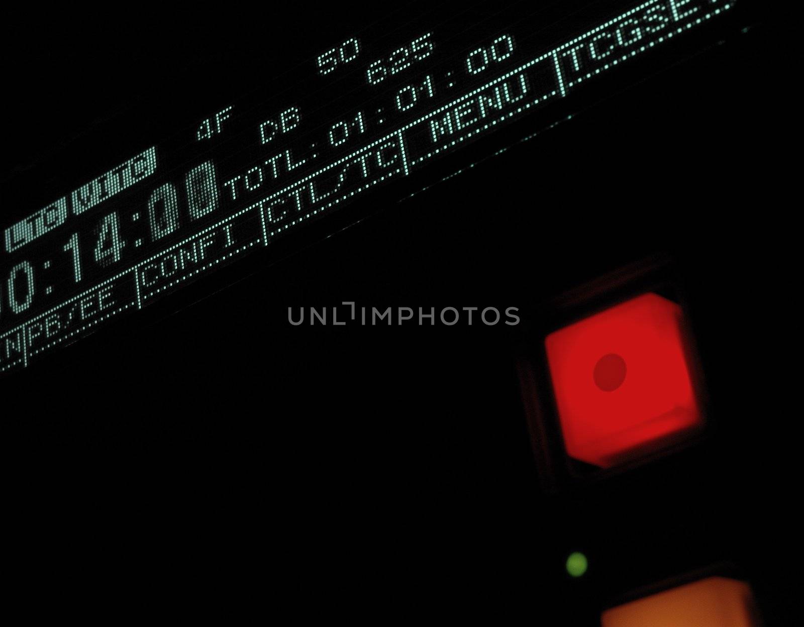Perspective macro shot of the display of the professional video recorder. 
Shallow dof. Visible data: timecode, record button
