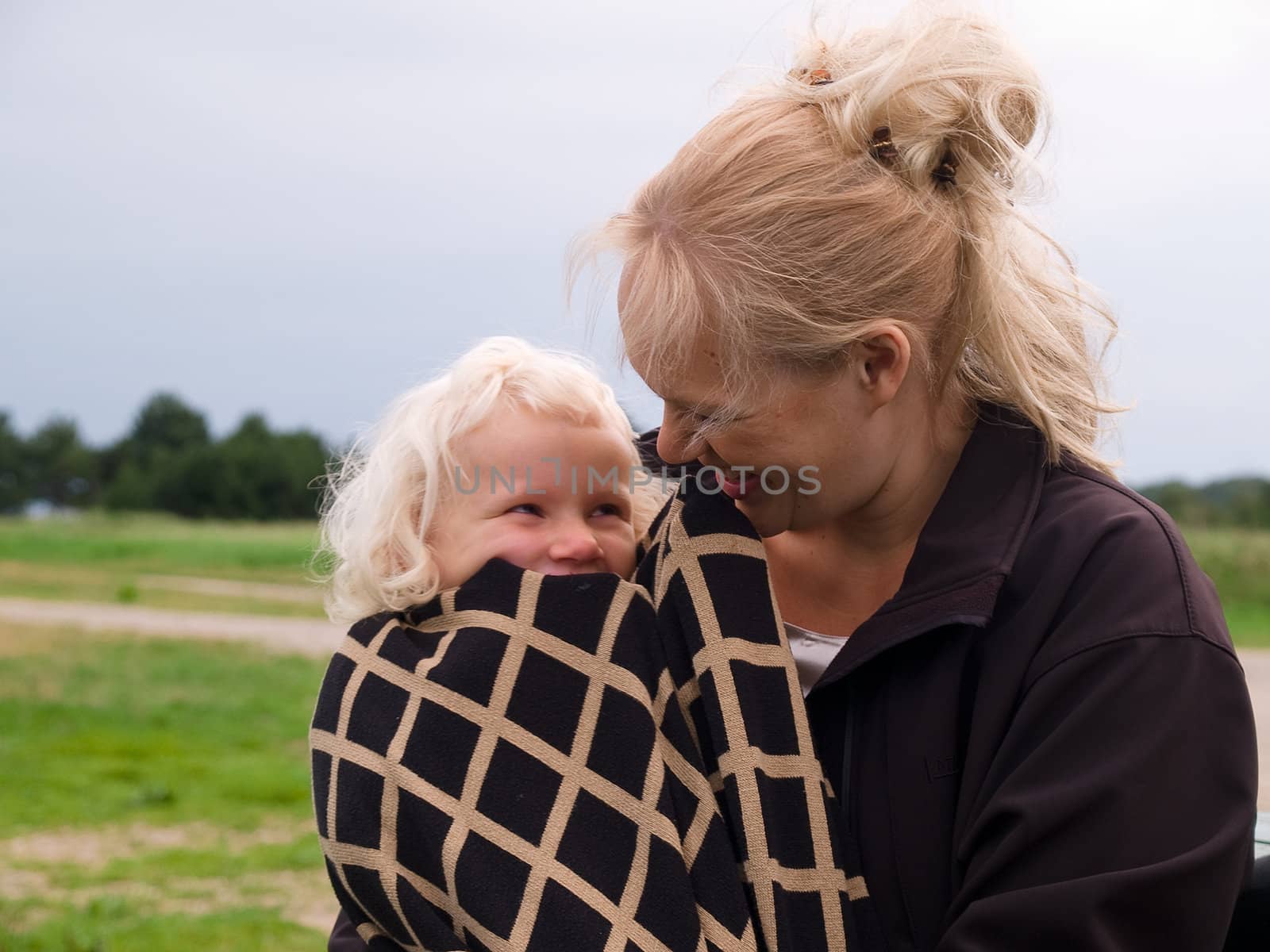 Close Up Of Affectionate Mother And Daughter hugging outdoors in nature