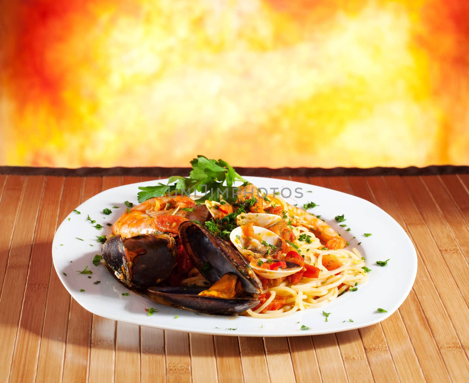 Spaghetti with mussels on a orange background
