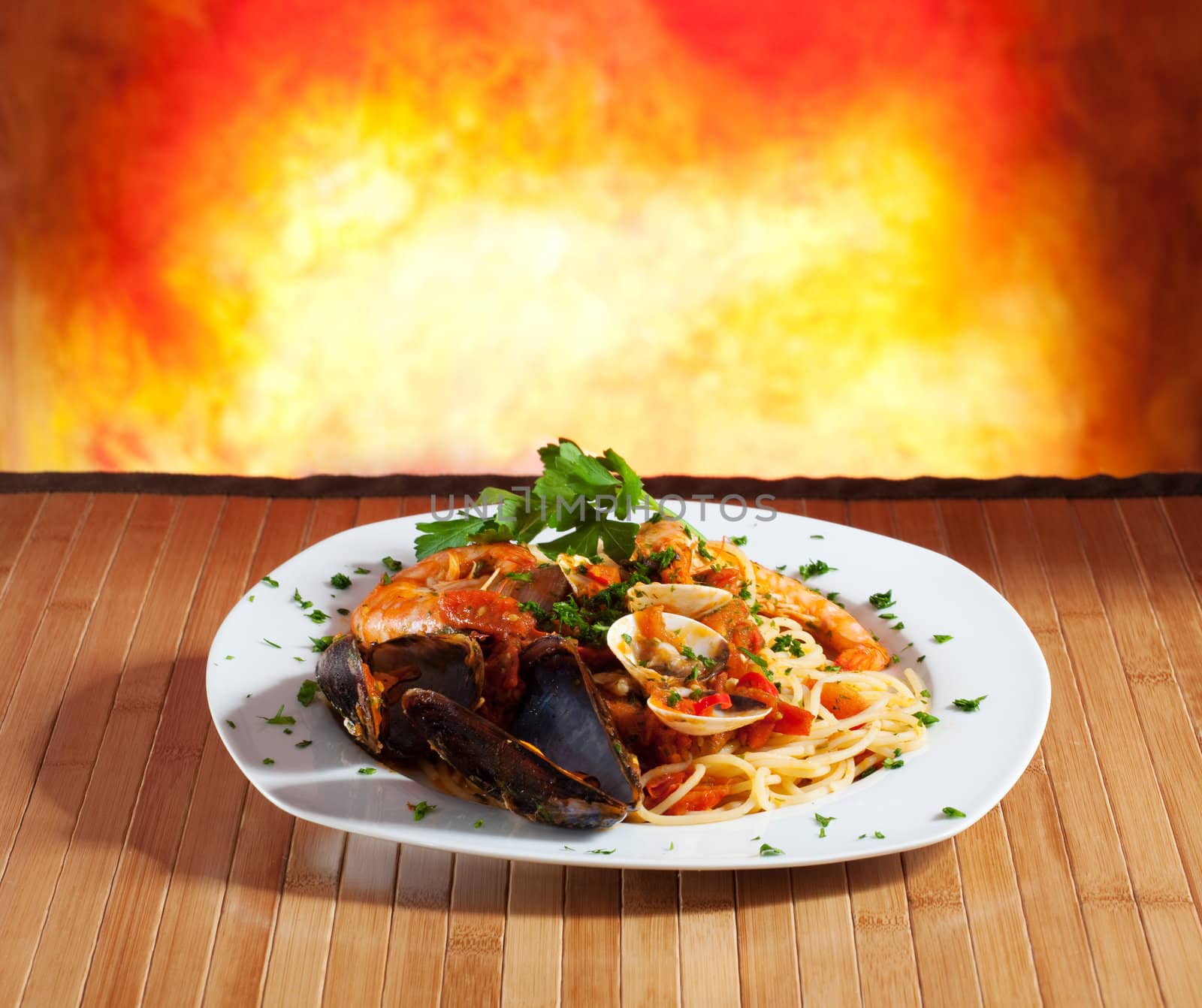 Spaghetti with mussels on a orange background