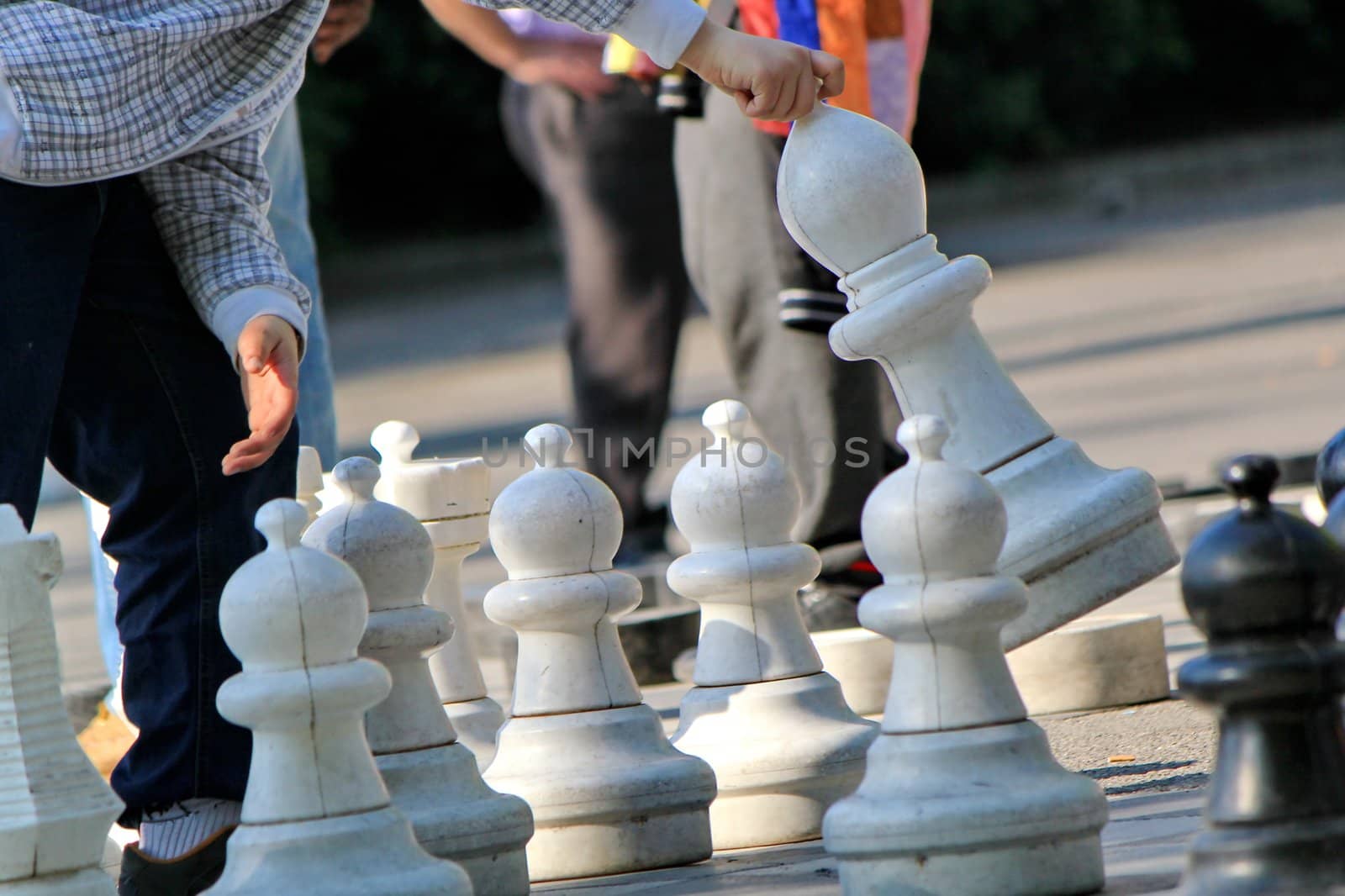 Man playing to an outdoor chess game