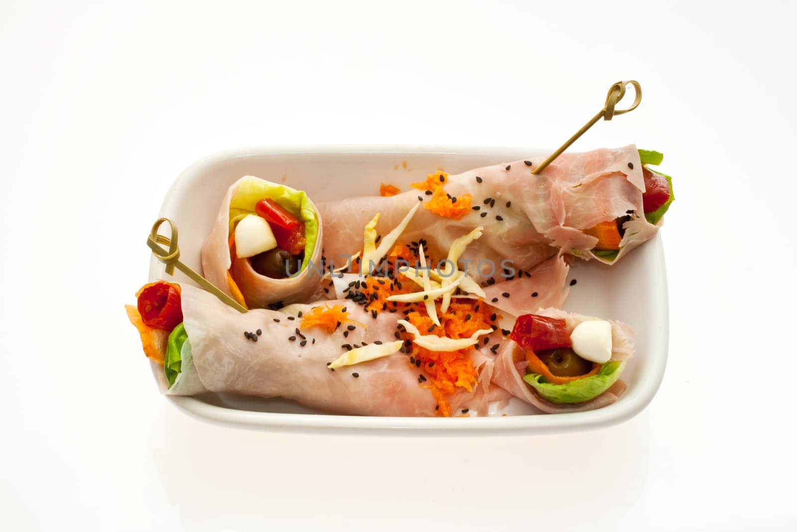 Saucer with appetizer stuffed with ham