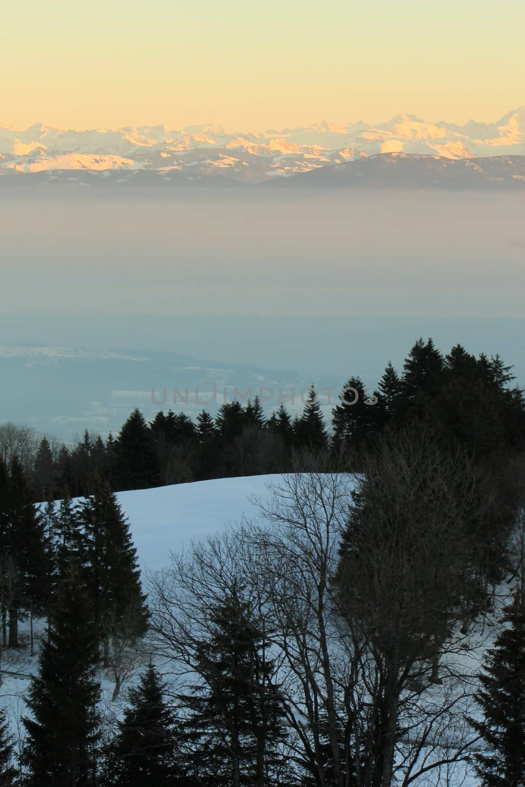 View on the Alps mountains by winter sunset