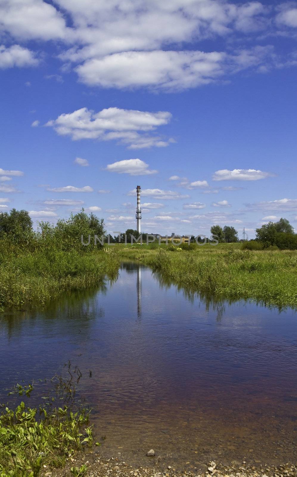 Industry chimney in water reflection