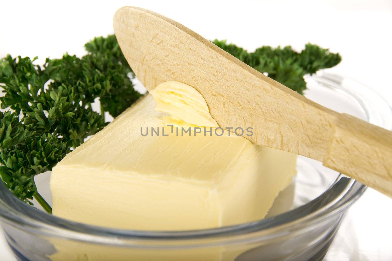 Butter with knife on the plate - isolated