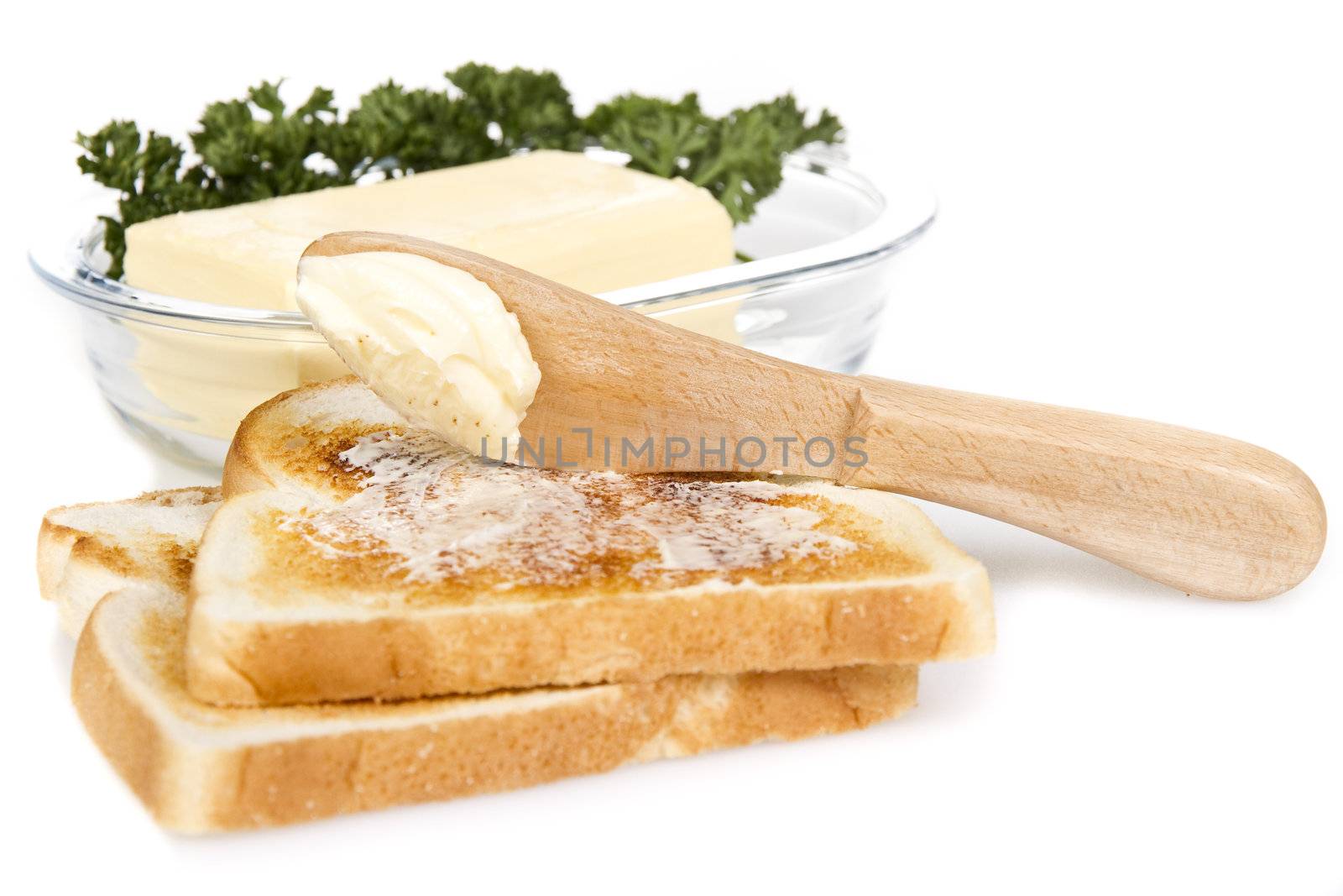 Toasts with butter and knife over white background