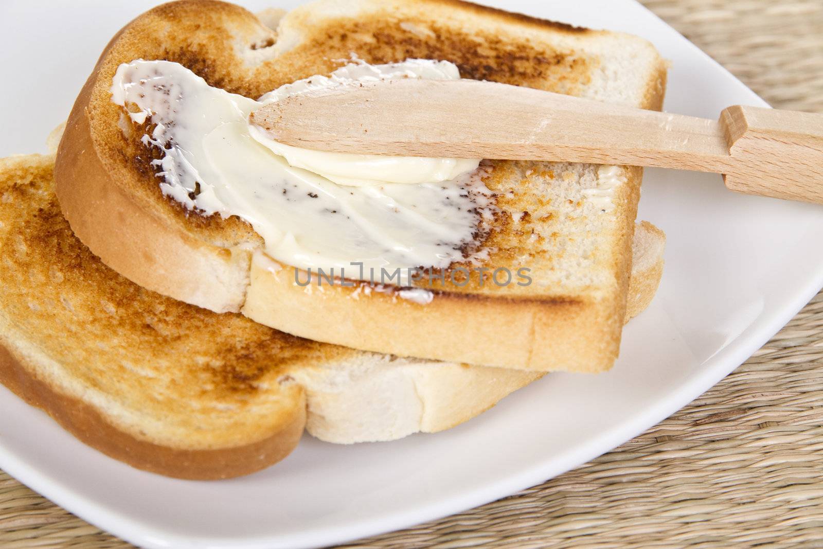 Spreading toasts by wooden knife