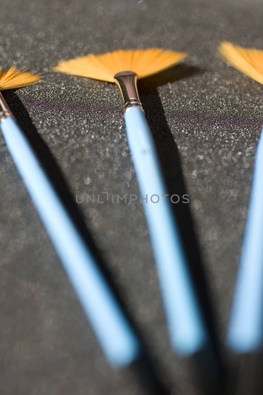 Fan shaped paintbrushes on anthracite background