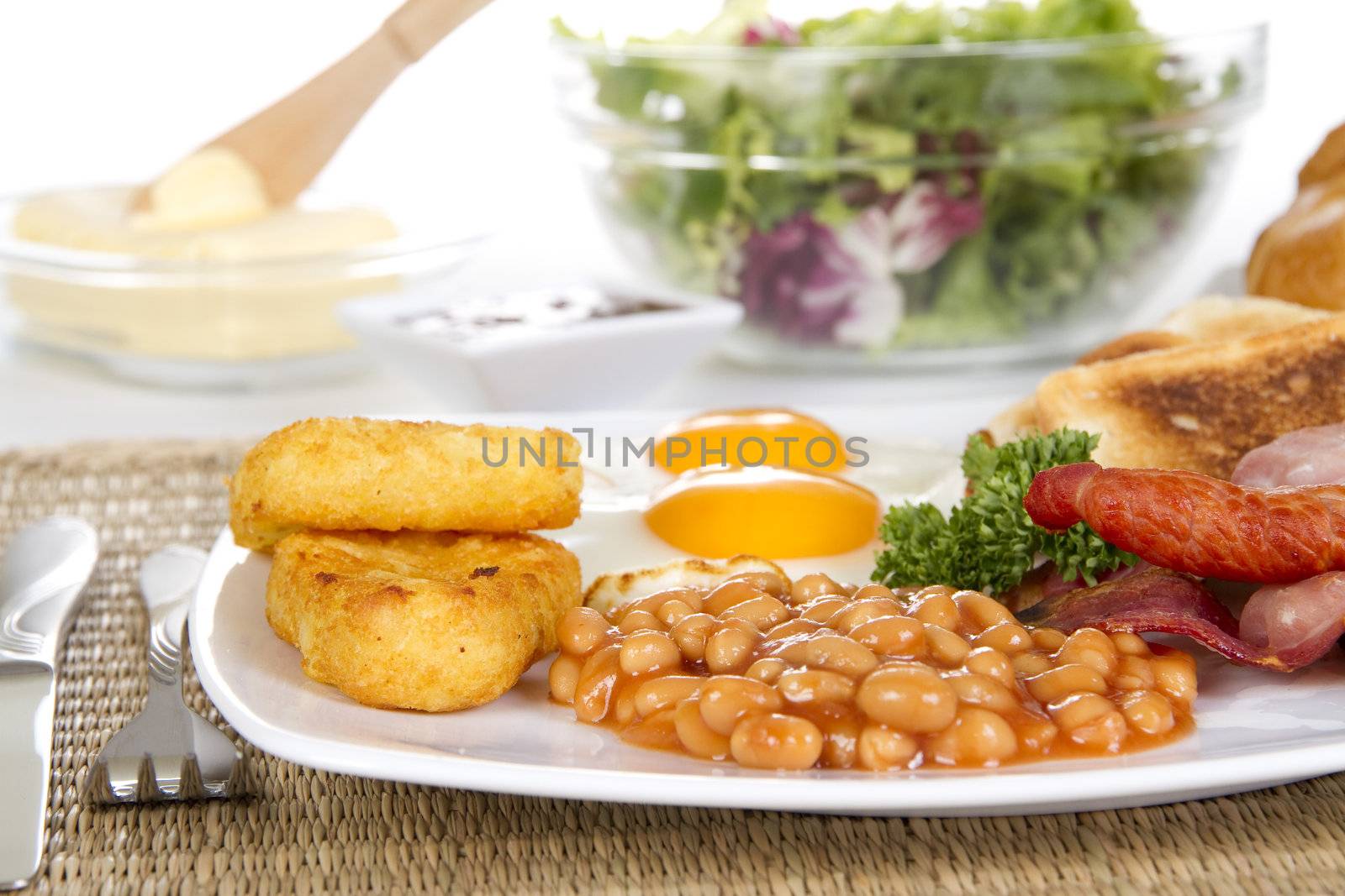 Breakfast with toasts eggs bacon beans and hash browns