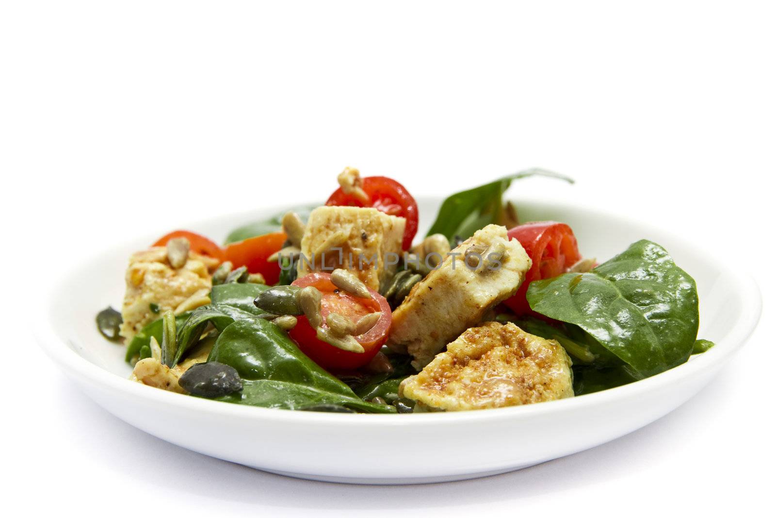 Spinach and chicken salad over white background